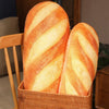 A loaf of golden-brown striped bread is displayed in a woven basket.