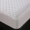White waterproof quilted mattress protector placed on a black surface.