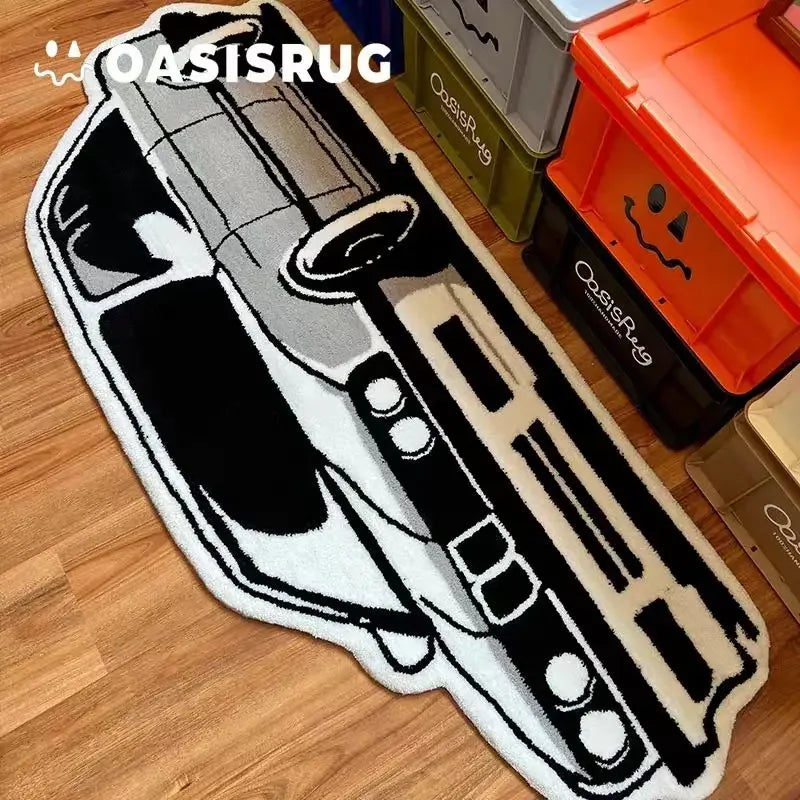 A black and white embroidered rug featuring a stylized pistol design on a wooden floor.