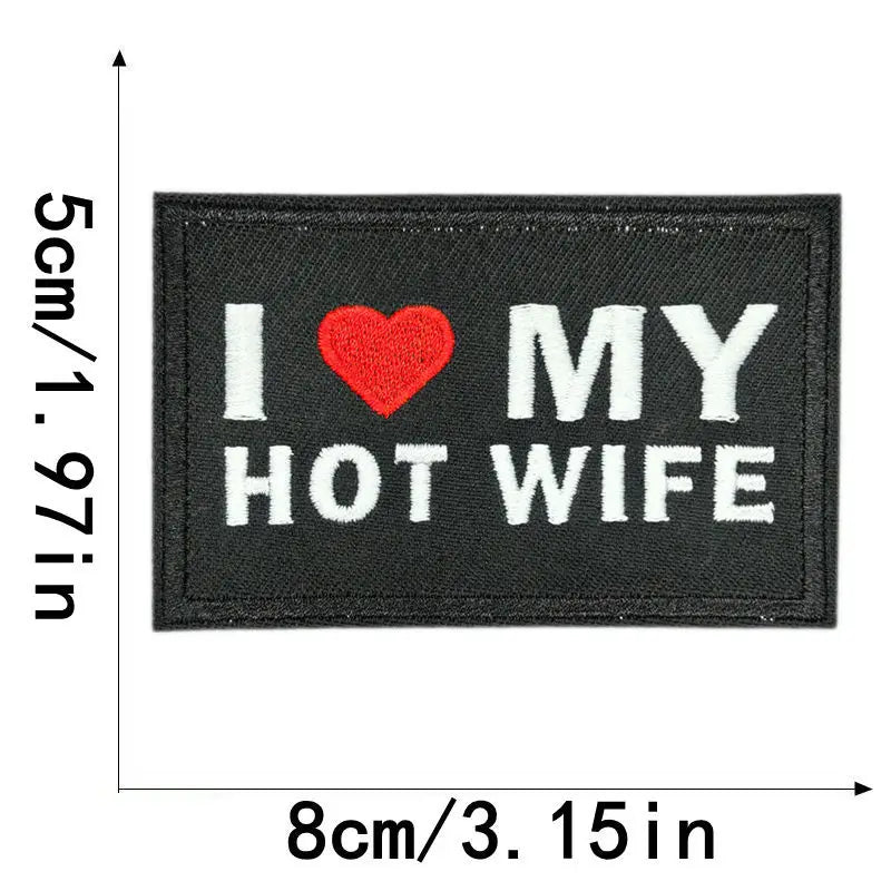 Black embroidered iron-on patch with white text I ❤️ MY HOT WIFE