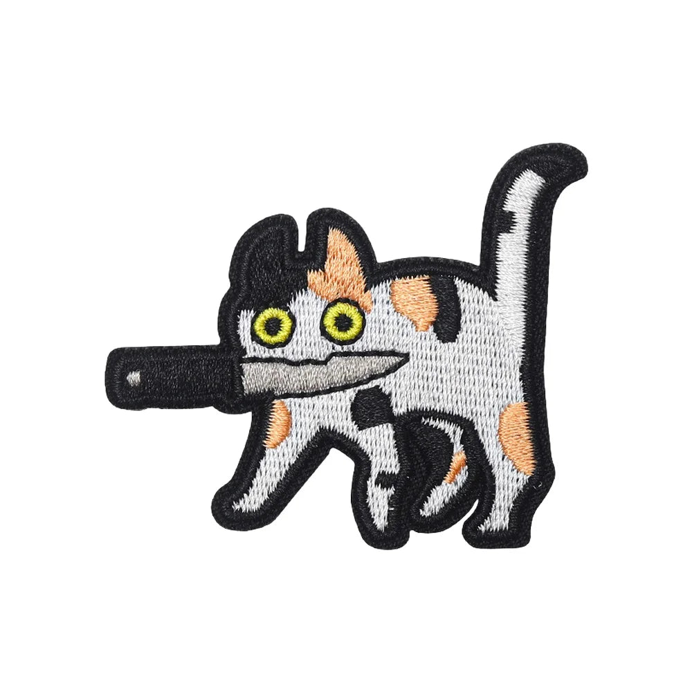 Embroidered tactical patch of a cat with black and white fur and yellow eyes