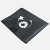 A black conductive grounding mattress pad with a white electrical cord and plug resting on the surface.