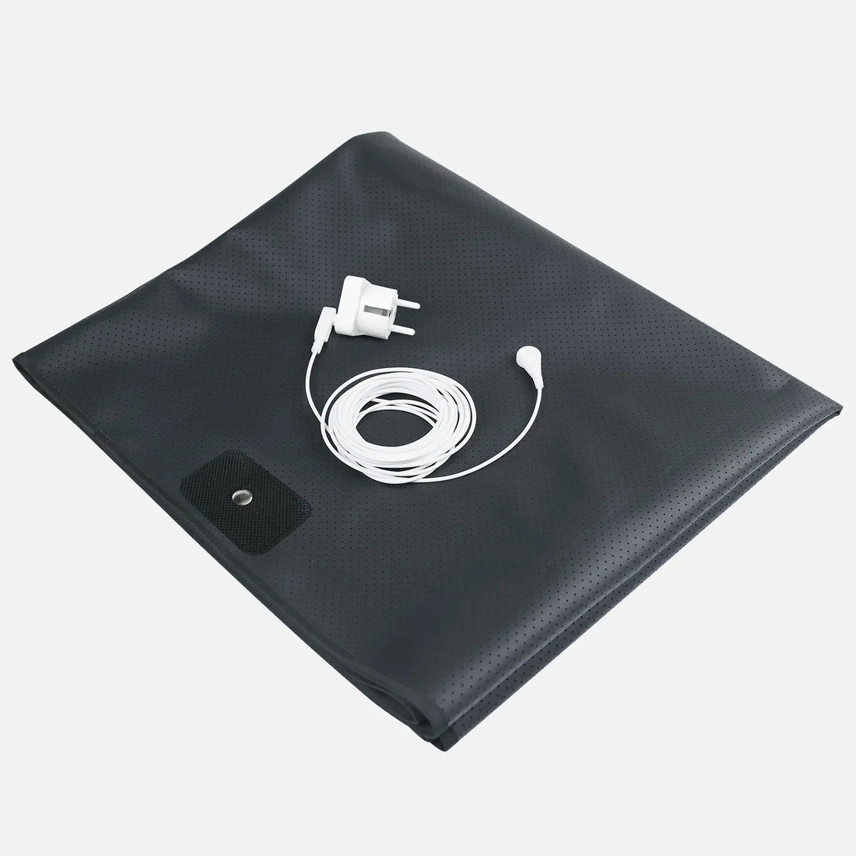 A black conductive grounding mattress pad with a white electrical cord and plug resting on the surface.