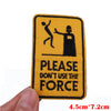 Yellow embroidered patch with black silhouette depicting a person striking another, featuring the text PLEASE DON'T USE THE F