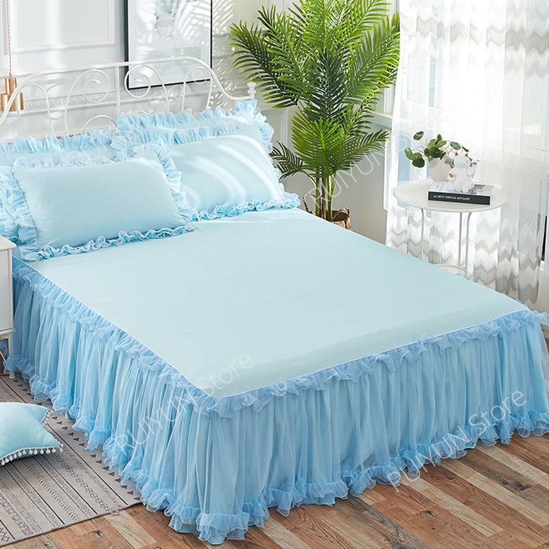 Light blue princess lace bed skirt set with ruffled fabric on a bed
