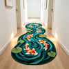 A plush rug featuring an artistic design of koi fish and lotus leaves in shades of teal, orange, and green.