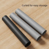 Three rolled heat-resistant silicone stove top cover mats lying on a wooden surface.