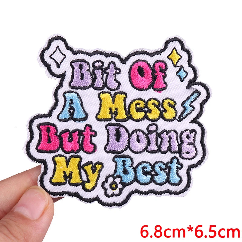 Pink letter embroidered iron-on patch with text Bit Of A Mess But Doing My Best