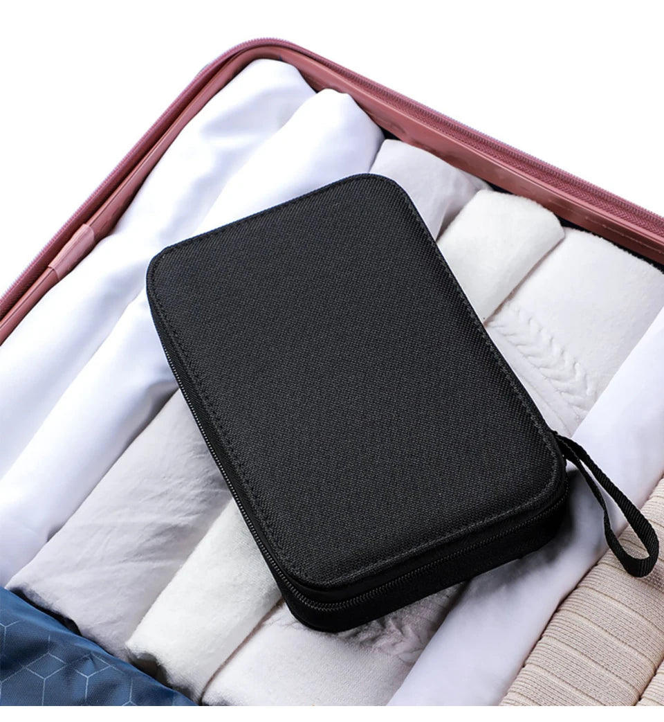 A black complete sewing kit for handicrafts and embroidery placed inside a pink carrying case with white fabric lining.