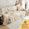 A beige and white striped sofa cover featuring a modern face design, displayed on a light-colored floor.