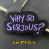 Black embroidered patch with purple text asking Why So Serious?