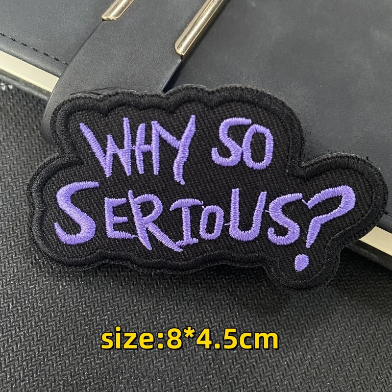 Black embroidered patch with purple text asking Why So Serious?