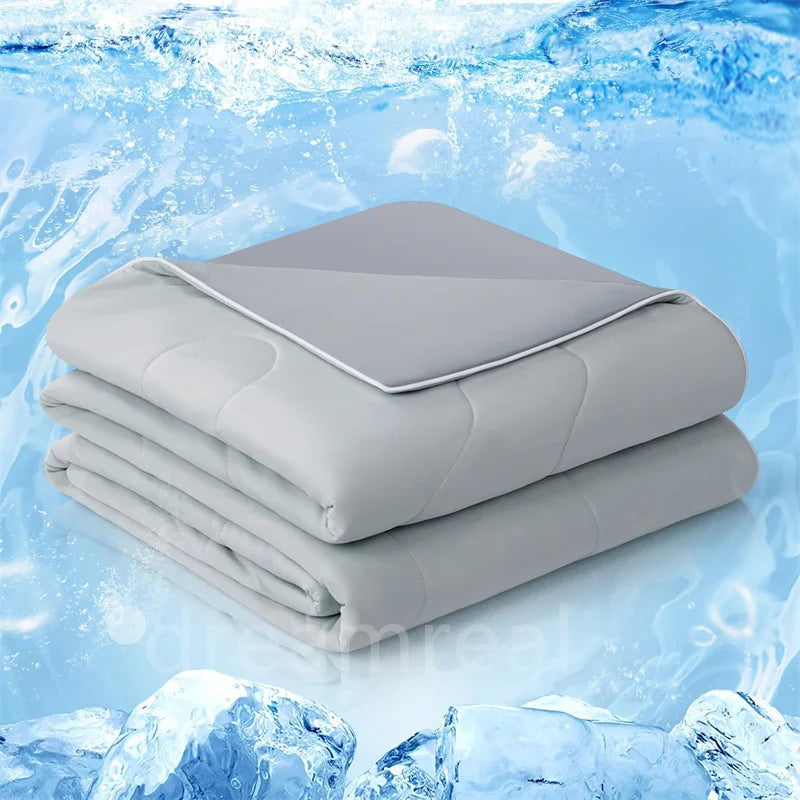 A stack of light gray lightweight cooling blankets resting on a blue, icy background.