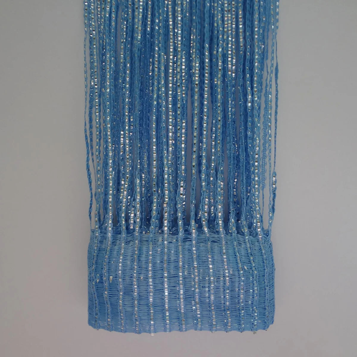 Blue decorative door string curtains with shimmering silver threads hanging vertically.