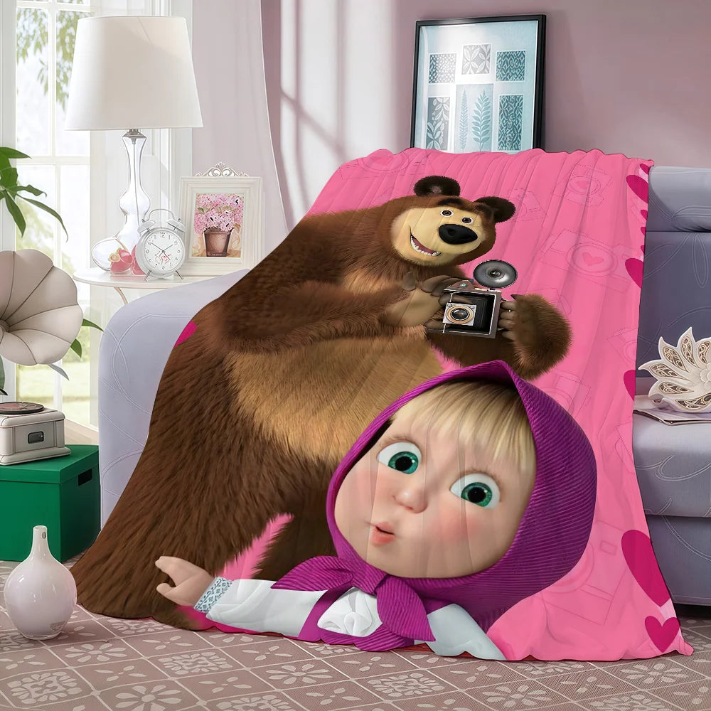 A plush bear and a baby character are featured on a pink fleece blanket.