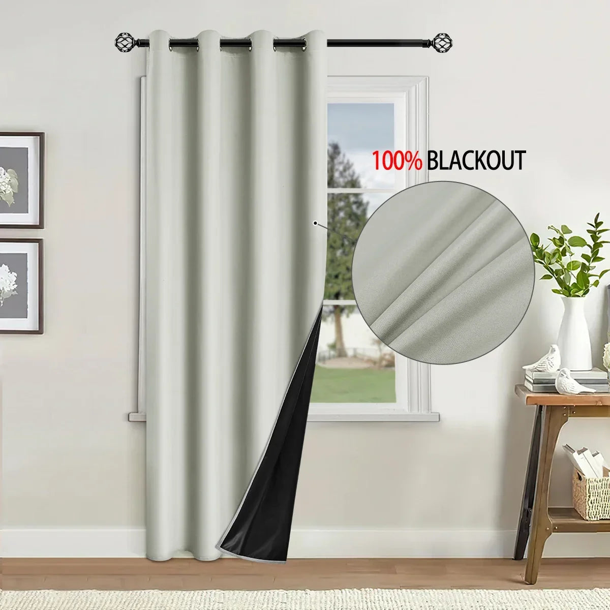 A close-up of a floor-length gray blackout curtain hanging in a window frame.