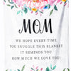 A white throw blanket with a floral print and the text MOM encouraging love.
