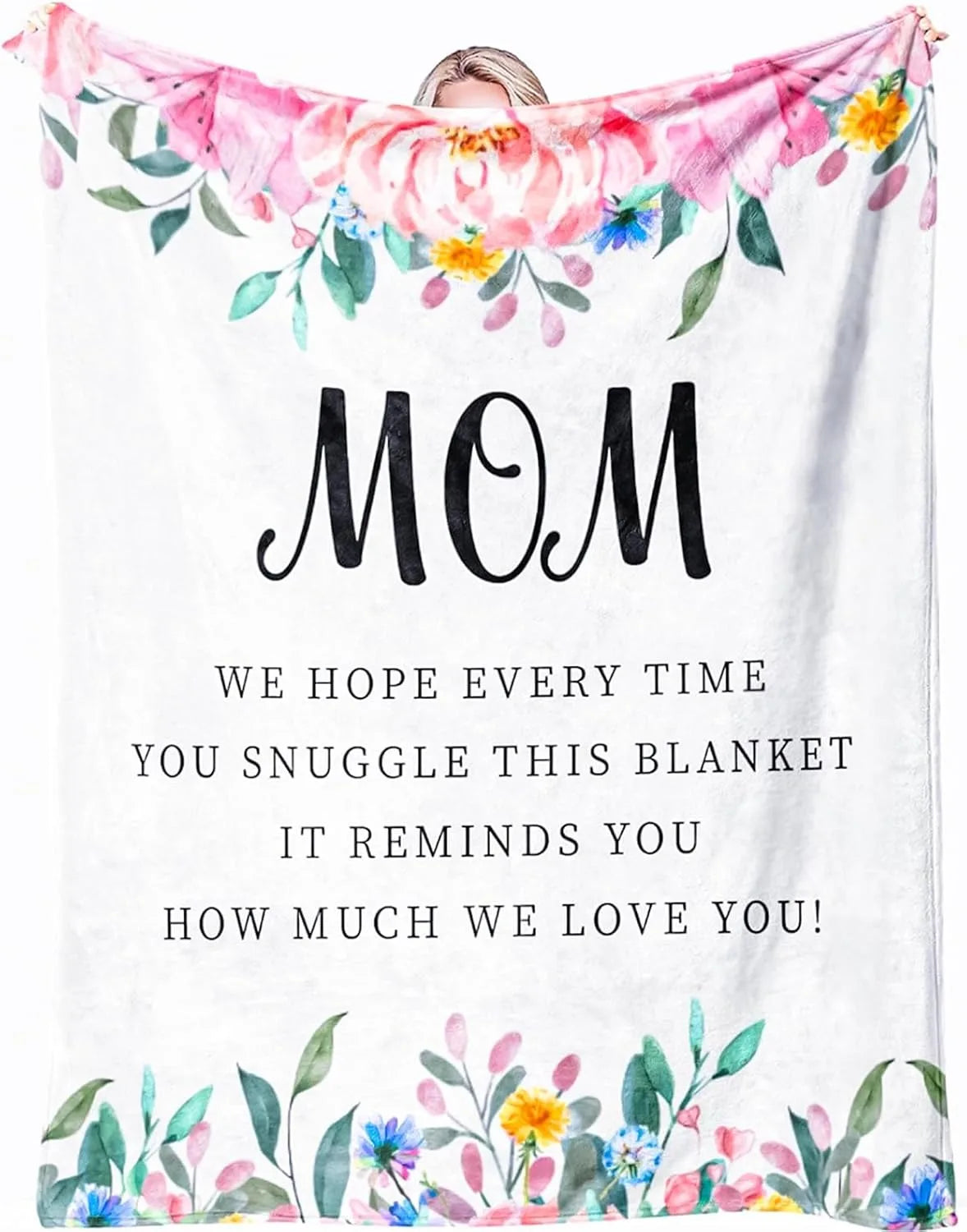 A white throw blanket with a floral print and the text MOM encouraging love.