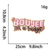 Pink embroidery patch with the text BOUJEE on a budget