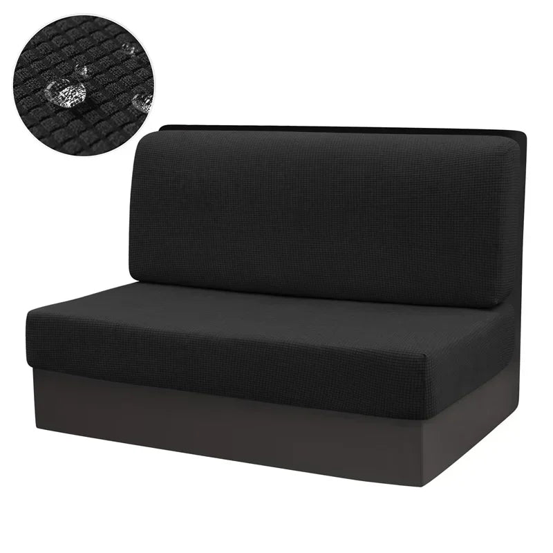 Black water repellent stretch sofa and chair covers with a circular textured pad.