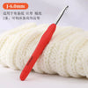 A red precision aluminum crochet hook with a J-6.0mm size is shown resting on a ball of white yarn.