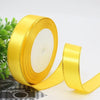 Roll of bright yellow gold edge satin ribbon for gift wrapping and crafts