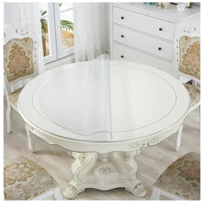 A round white PVC table with a decorative print cloth is shown in a bright room.