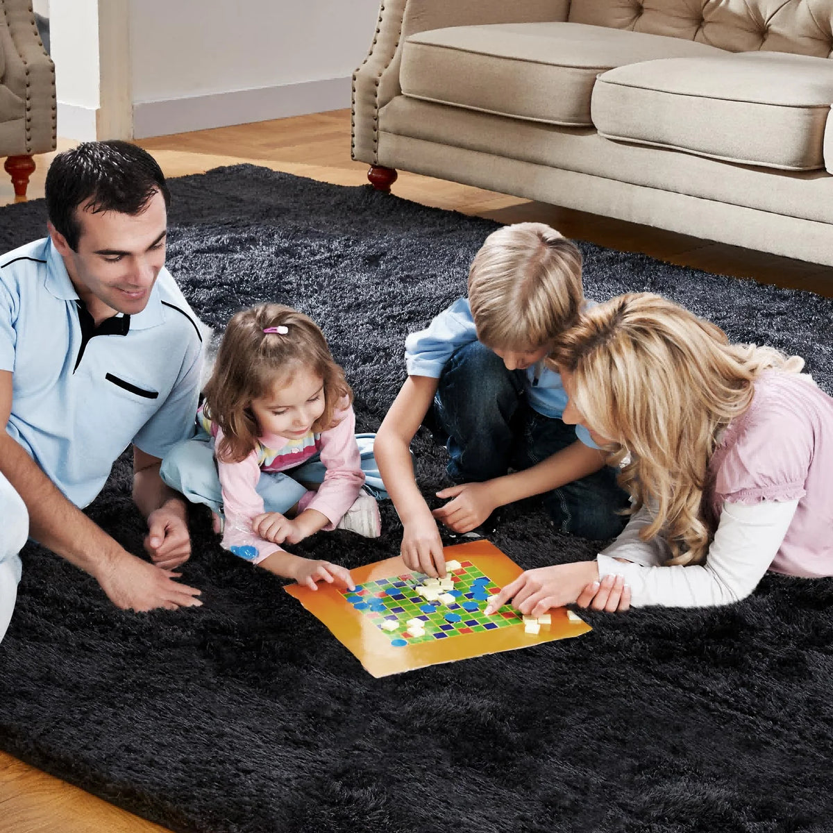 A family is playing with a colorful wooden puzzle on a dark rug in a living room.