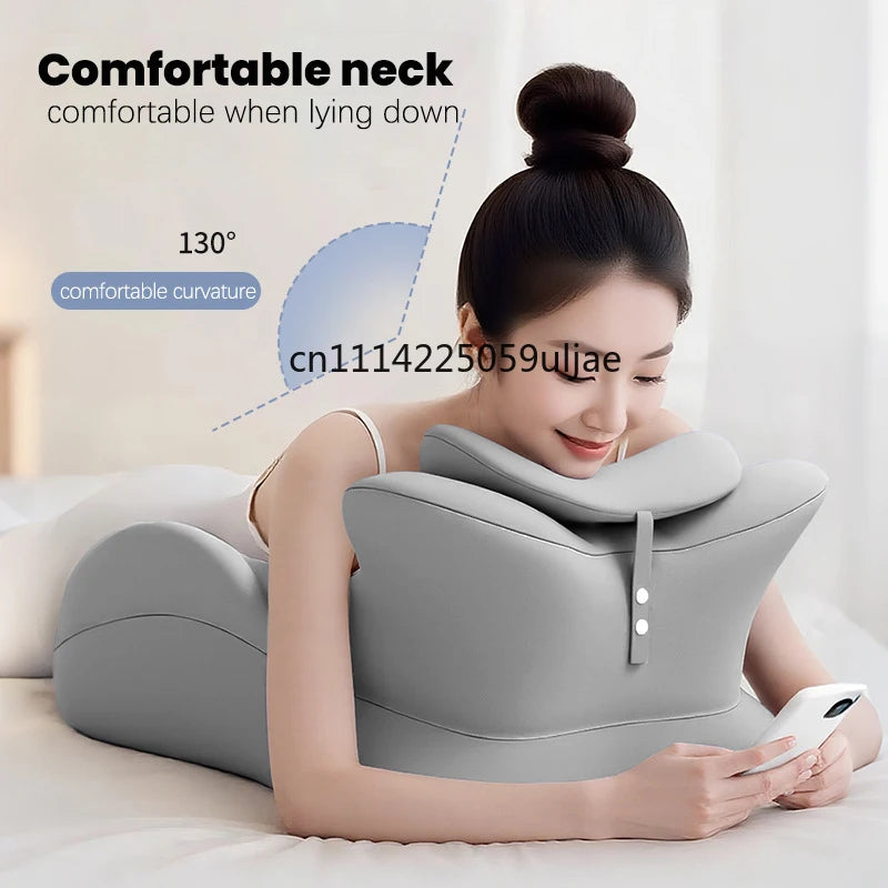 A woman is lying down comfortably using a gray ergonomic memory foam wedge pillow for neck support.