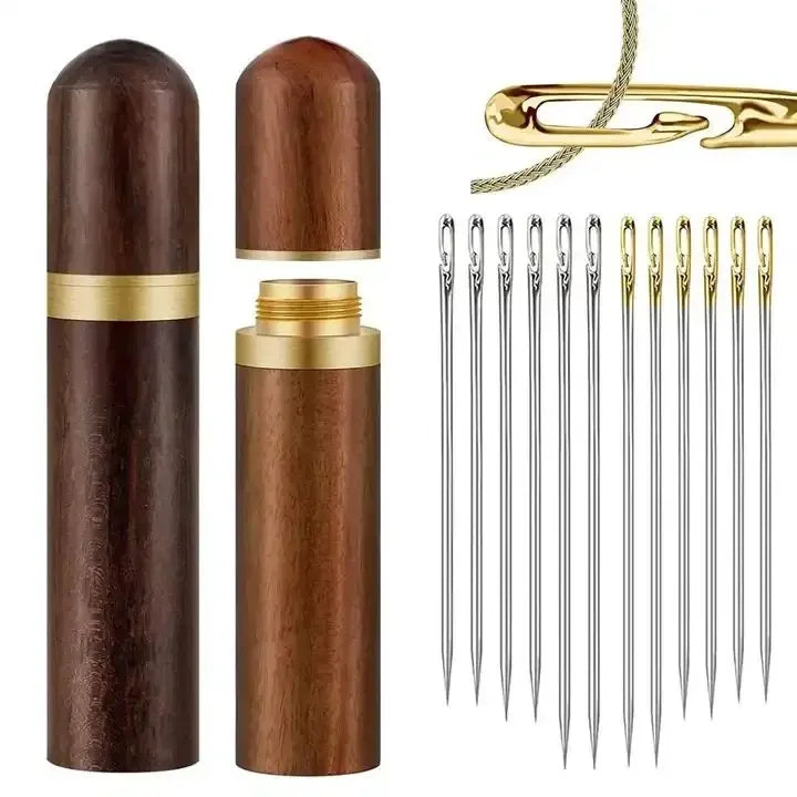 A set of stainless steel sewing needles and a gold-colored cylindrical container for storage.