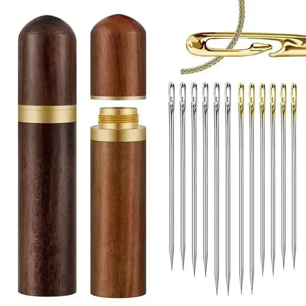 A set of stainless steel sewing needles and a gold-colored cylindrical container for storage.