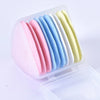 A clear plastic container holds a set of colorful seam ripper tools and thread cutters in various pastel shades.