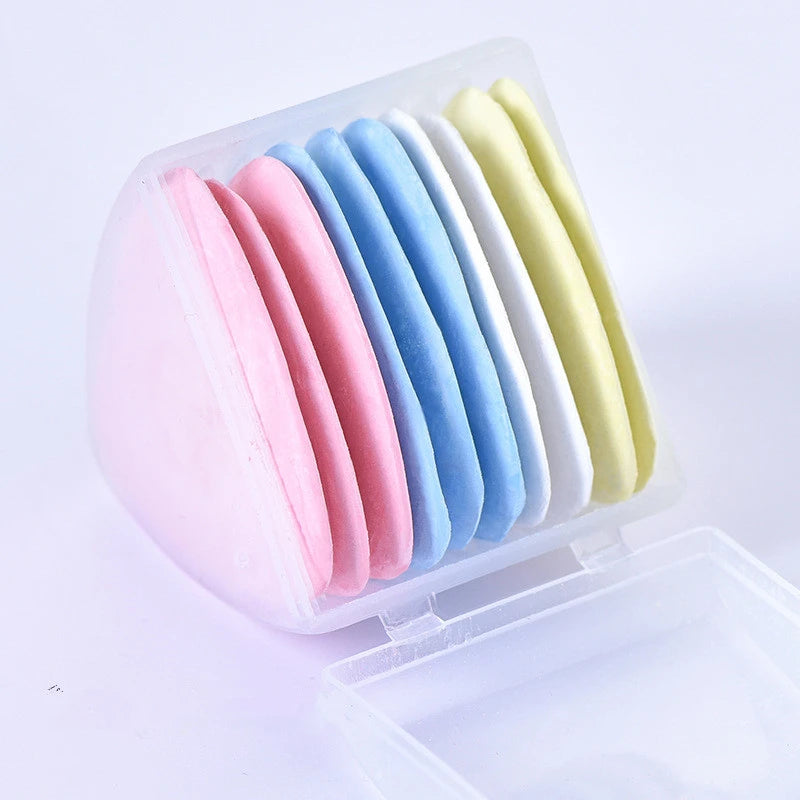 A clear plastic container holds a set of colorful seam ripper tools and thread cutters in various pastel shades.