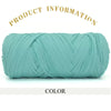 A skein of teal green thick polyester blended yarn is shown rolled up against a white background.