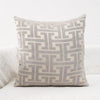 A square lumbar pillow cover with a light gray and beige geometric maze pattern.