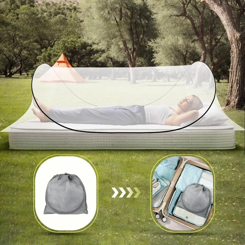 Portable mosquito net pop-up bed set up on the ground with a person relaxing under it.