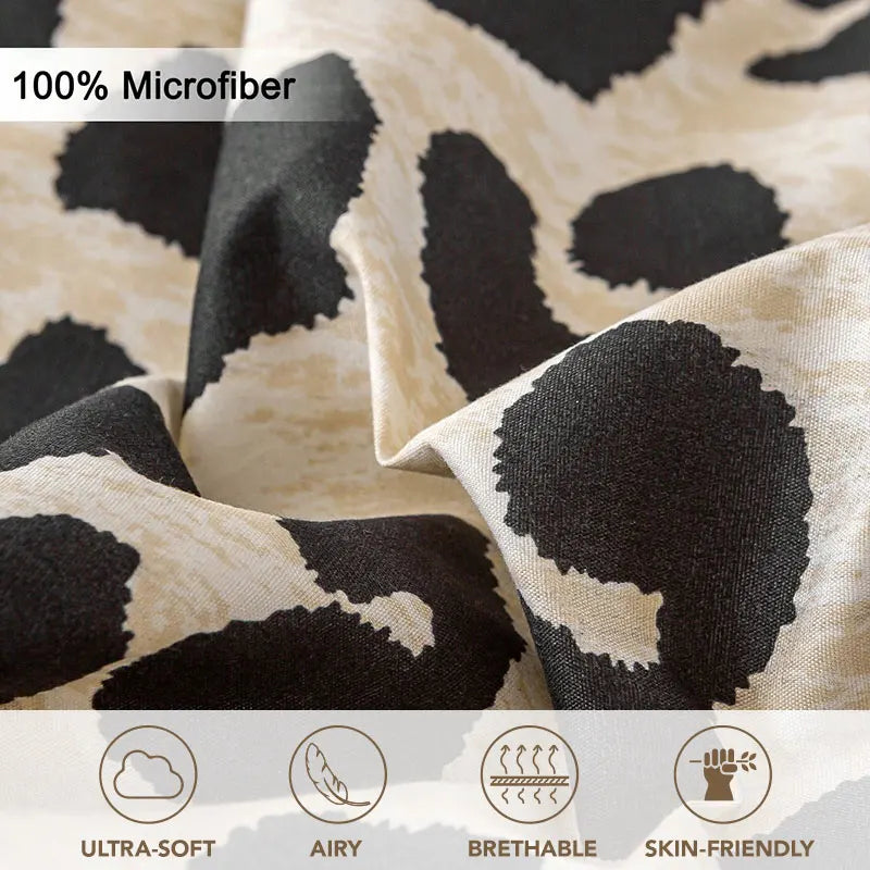 Close-up view of beige and black leopard print microfiber fabric showing texture and drape.