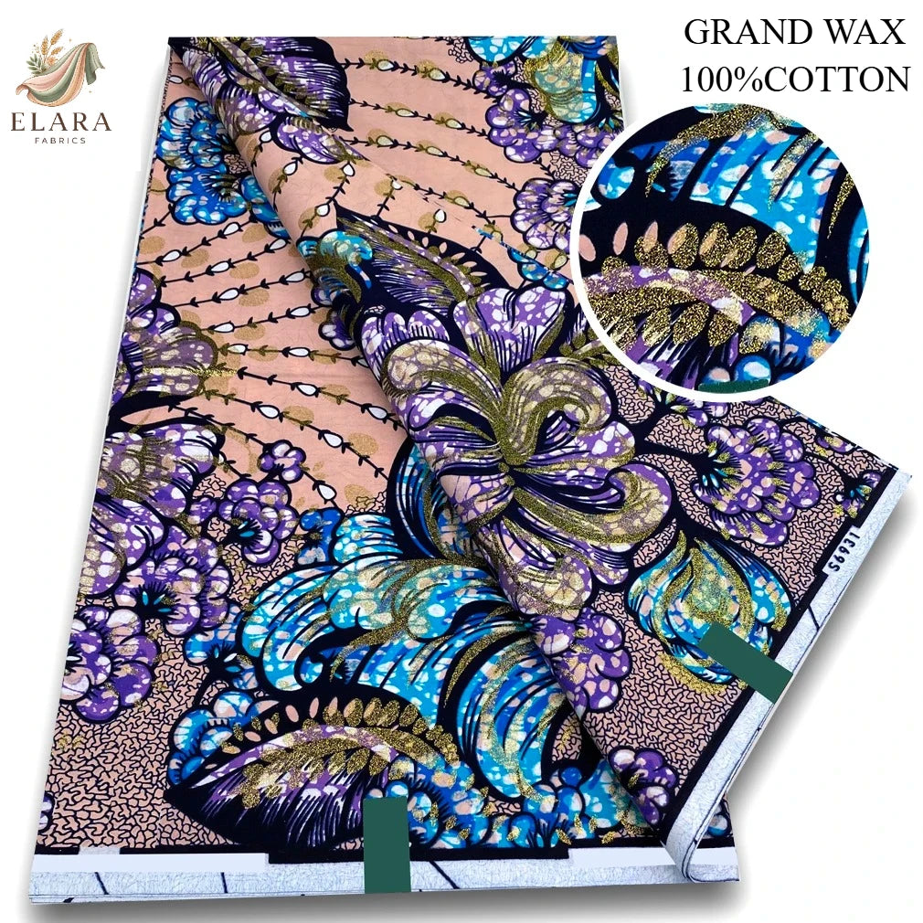 A bolt of grand wax print fabric featuring vibrant purple, blue, and gold floral patterns on a light pink background.