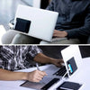 A person is using an adhesive laptop back storage pouch to secure a laptop.