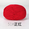 A ball of bright red organic cotton 4ply knitting yarn for crafts.