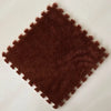 A square brown plush interlocking puzzle rug mat with a textured surface.