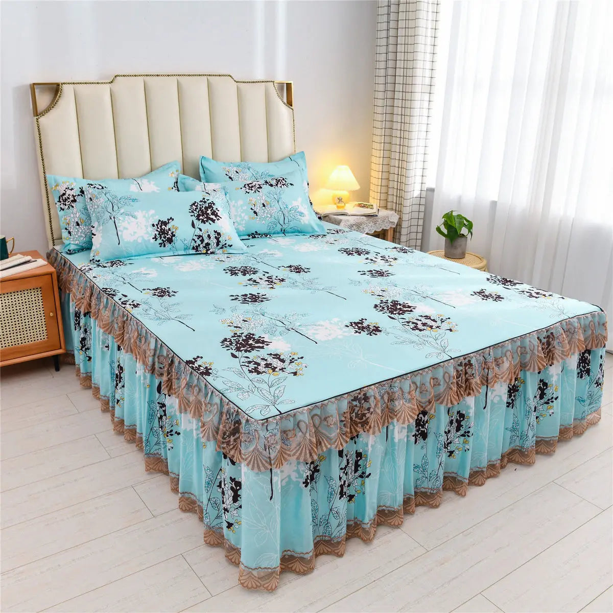 Light blue floral bed skirt with lace trim protecting a bed mattress.