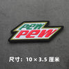 A embroidered patch featuring the text PEW in green and red on a black background.