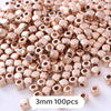A pile of small rose gold colored geometric acrylic beads for jewelry making