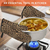 A pair of animal print heat resistant oven and microwave gloves resting above a bowl of soup on a stovetop.