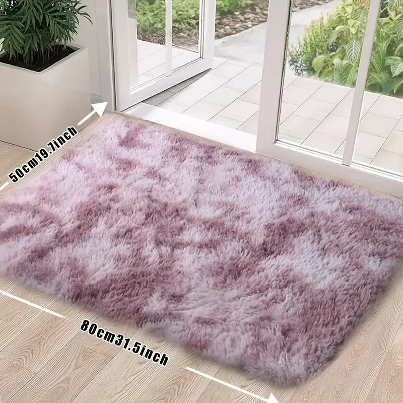 A fluffy mauve silk wool floor rug placed on a light wood floor near a glass door.