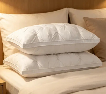 A white hotel-grade memory foam sleeping pillow resting on a beige bed with light wood paneling.