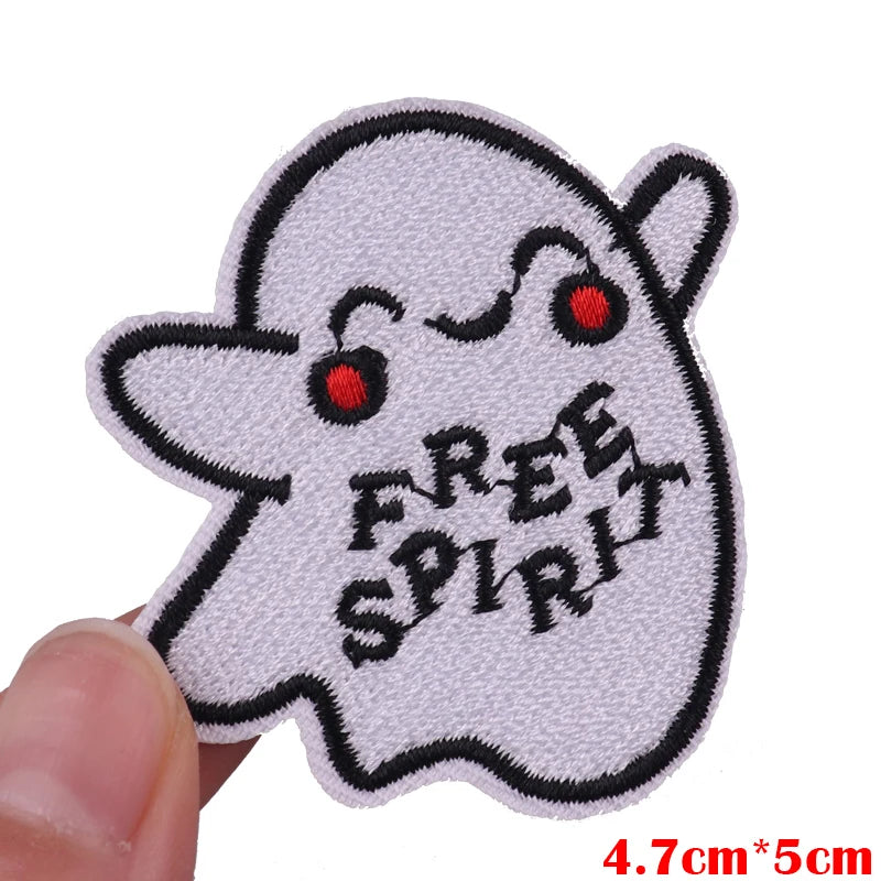 White embroidered patch of a cute ghost character with red eyes and the text FREE SPIRIT