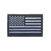 A black flag patch featuring the design of the American flag with stars and stripes.