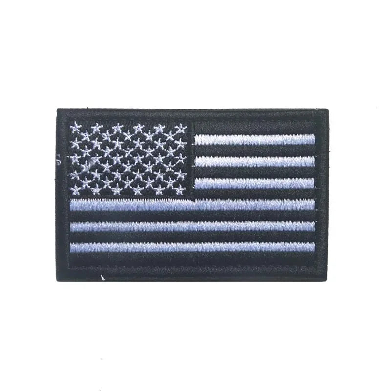 A black flag patch featuring the design of the American flag with stars and stripes.
